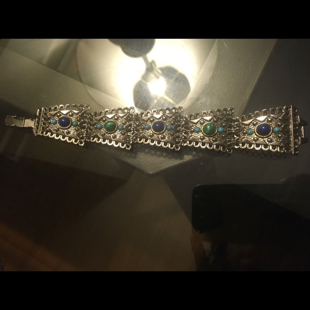 Silver colour metal bracelet with blue, green, and turquoise stones.